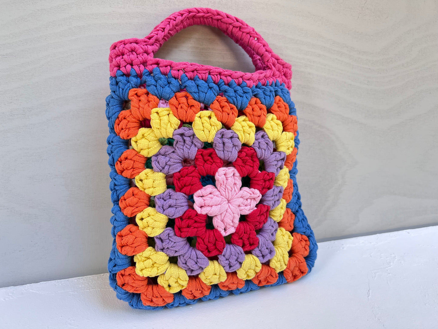 Crocheted colourful granny square tote purse