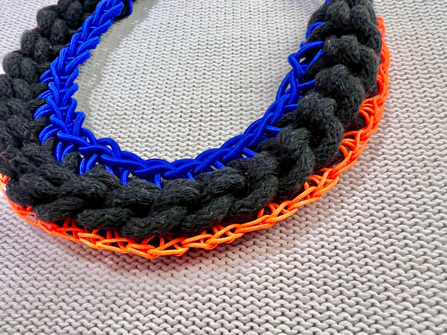 Black rope necklace with electric blue and neon orange accents