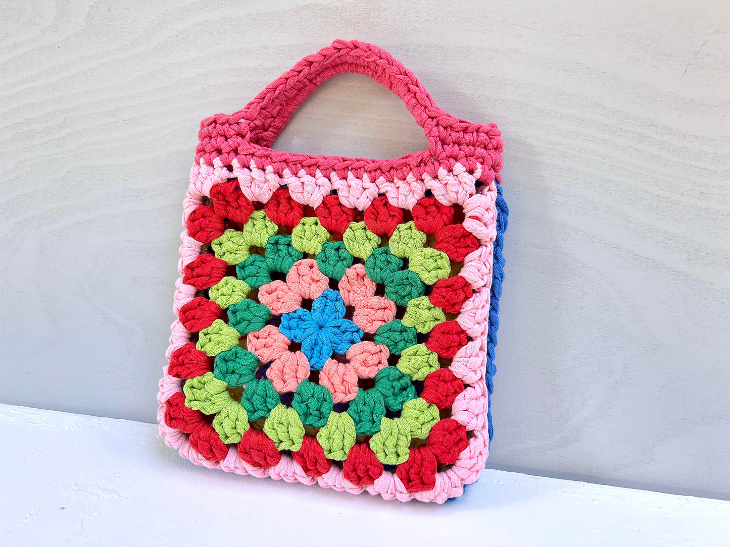 Crocheted colourful granny square tote purse